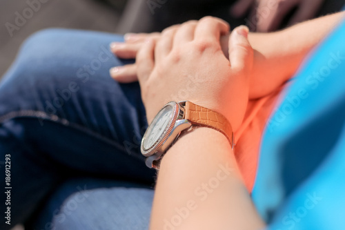 watch with leather strap on the girl s hand