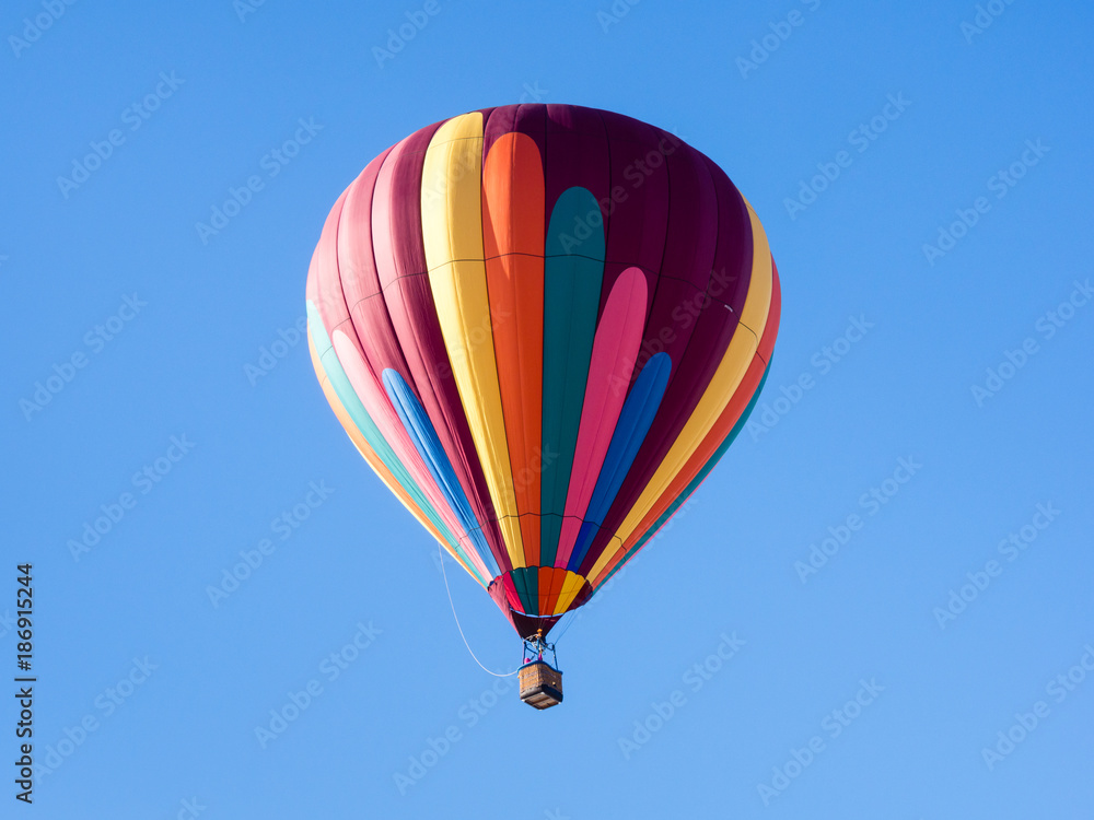 Colorful hot air balloon flying in the bright blue sky during Winthrop Balloon Festival in Washington state Colorful hot air balloon flying in the bright blue sky during Winthrop Balloon Festival in Washington state