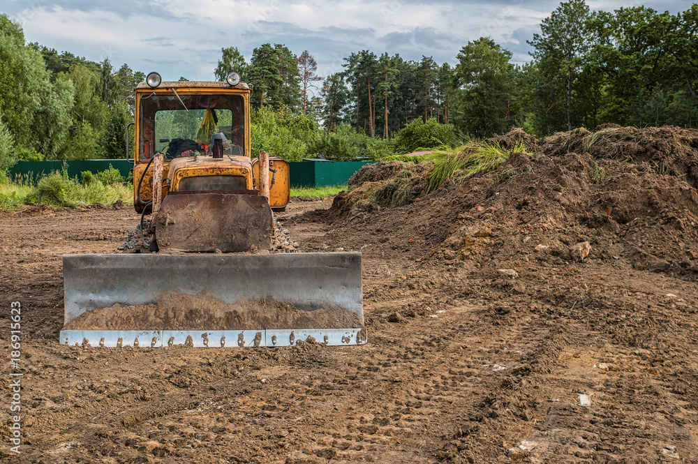 The excavator cleared the land leaving traces . Selective focus. Copy space. The excavator cleared the land leaving traces . Selective focus. Copy space.
