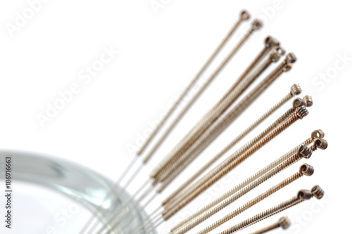 Silver needle acupuncture on an isolated white background. Close-up.