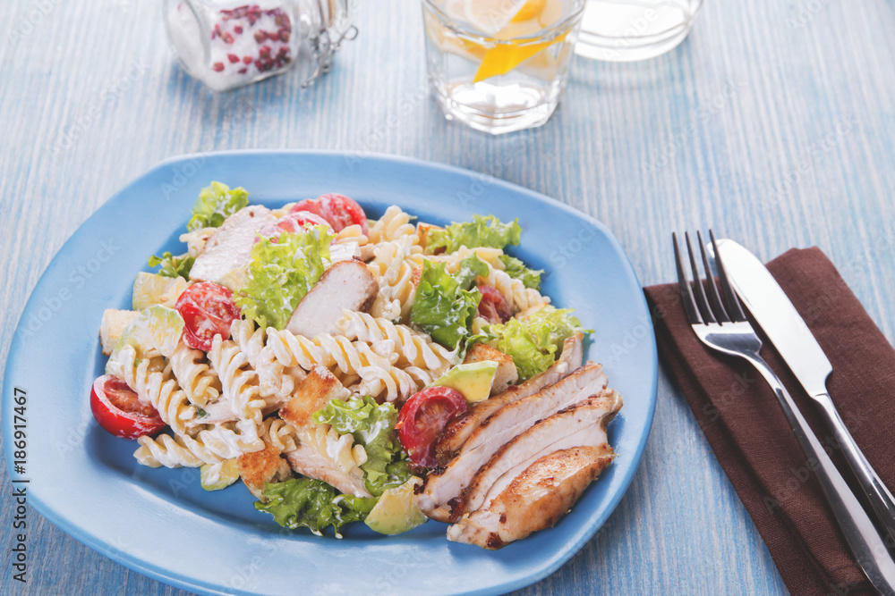 caesar salad pasta avocado chicken fillet tomato sauce close up caesar salad pasta avocado chicken fillet tomato sauce close up