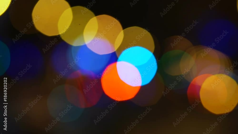 The concept of festive design. Blurred lights of the city before Christmas. Colored lights, out-of-focus machines and restaurants, bokeh. A frame of sparkling Bengal lights as a place for your text. The concept of festive design. Blurred lights of the city before Christmas. Colored lights, out-of-focus machines and restaurants, bokeh. A frame of sparkling Bengal lights as a place for your text.
