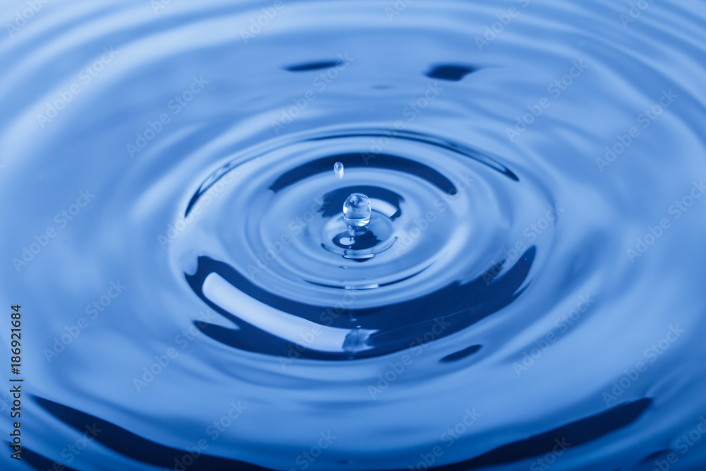 Macro shot of water splash on blue background Macro shot of water splash on blue background