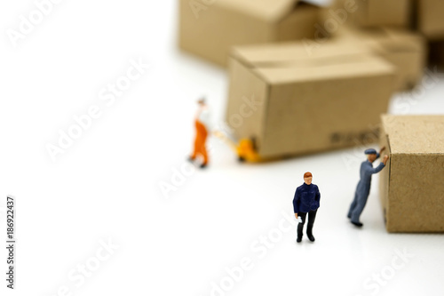 Miniature people: Worker and box with copy space using as background shipping, rent container, business concept.