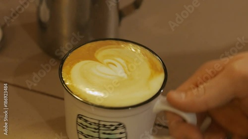 pouring stream milk into a cup of coffi photo