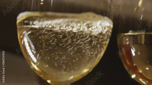 White wine poured into glass photo