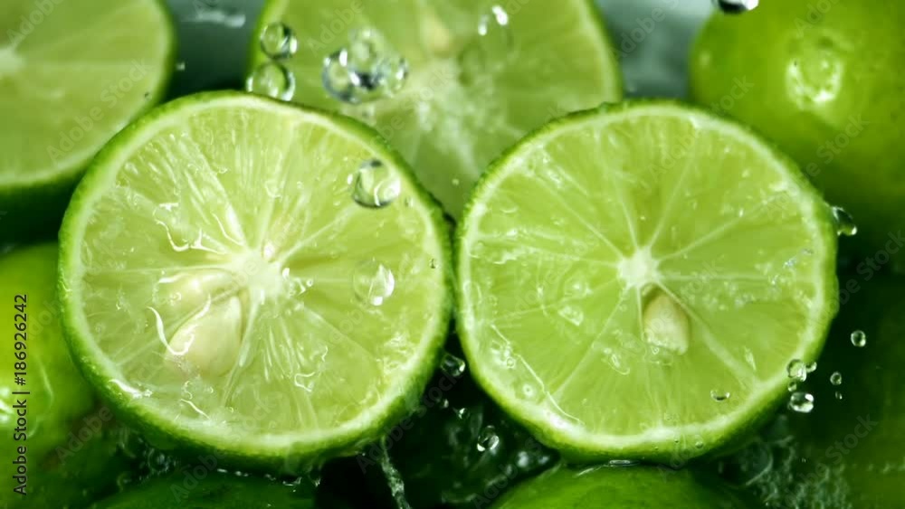 Limes Cut with Water Drops Slow Motion