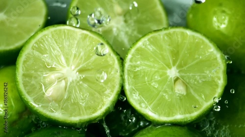 Limes Cut with Water Drops Slow Motion 