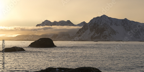 Rock formations in sea during sunset, Lofoten, Nordland, Norway