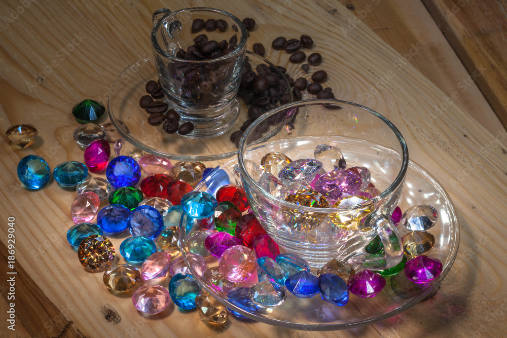 colorful gemstones on pine wood table with coffee cup