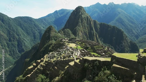 panning left shot of peru's famous lost inca city of machu picchu on a sunny morning