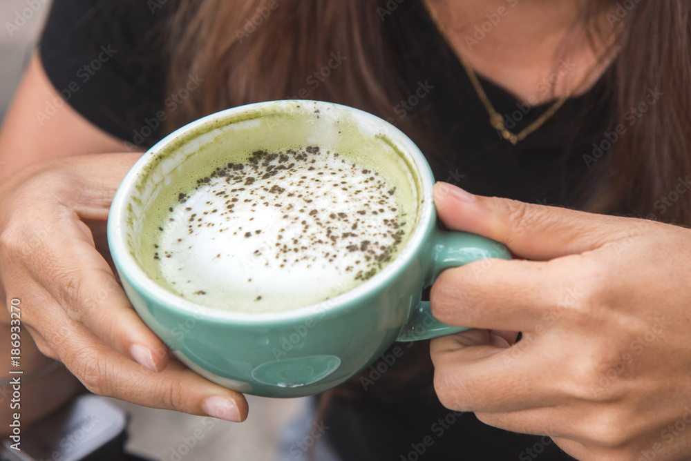 woman's hand holding a cup of hot coffee. woman's hand holding a cup of hot coffee.