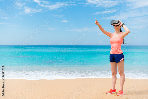 beautiful fitness traveler standing on beach