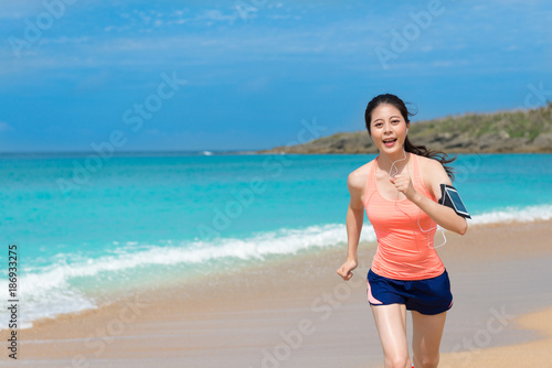 happy girl running on beach to train and workout