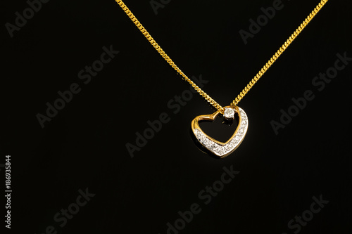 gold necklace and heart shape pendant