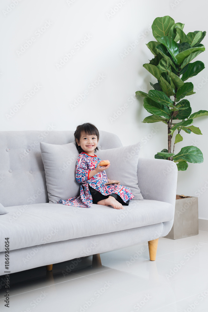 Beautiful little asian girl playing on the couch Beautiful little asian girl playing on the couch