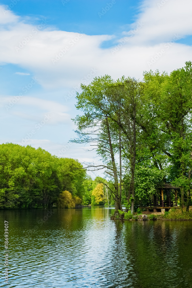 Pond in the Victory Park in Minsk with a garden house under the 