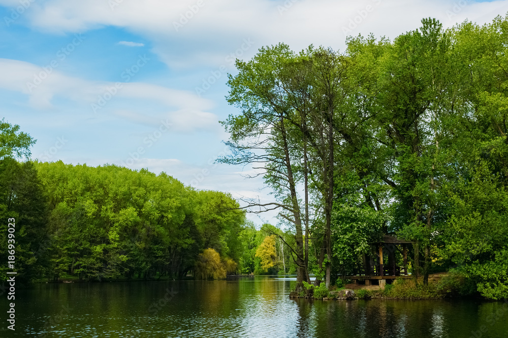 Garden house under the trees on the shore of the lake Garden house under the trees on the shore of the lake