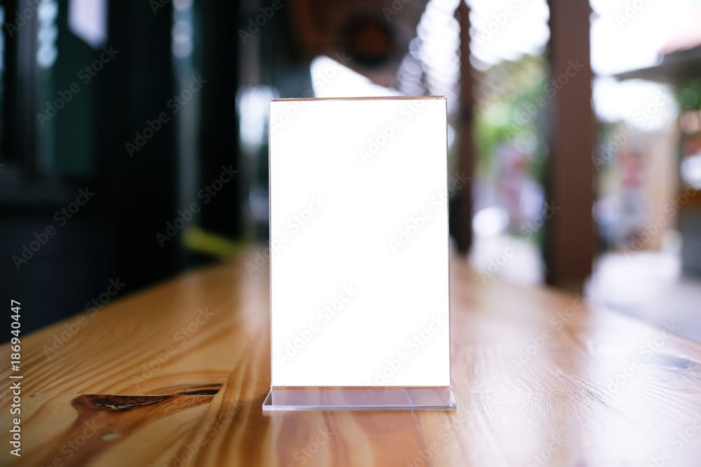 Mock up Menu frame standing on wood table in Bar restaurant cafe. space for text Mock up Menu frame standing on wood table in Bar restaurant cafe. space for text
