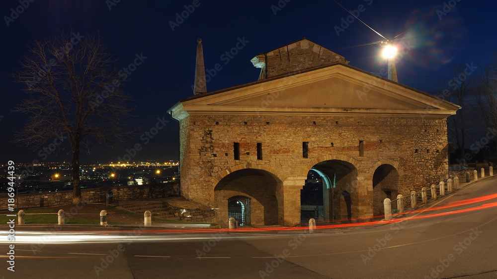 Bergamo, the old city. One of the beautiful town in Italy. Lombardy. Landscape on the old gate named San Giacomo door during the evening with trails of headlights