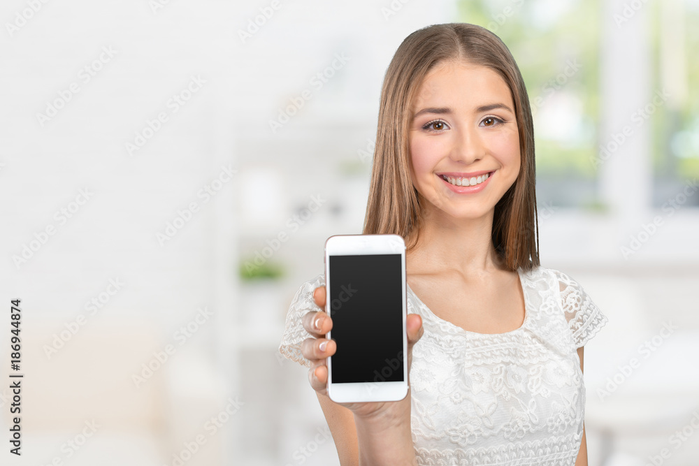 Happy pretty woman showing a blank smart phone screen Happy pretty woman showing a blank smart phone screen