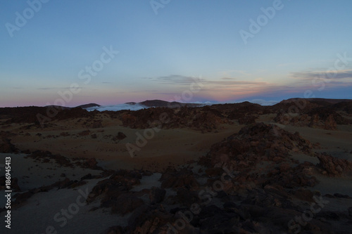 Desert landscape with sunset light on mountains in background