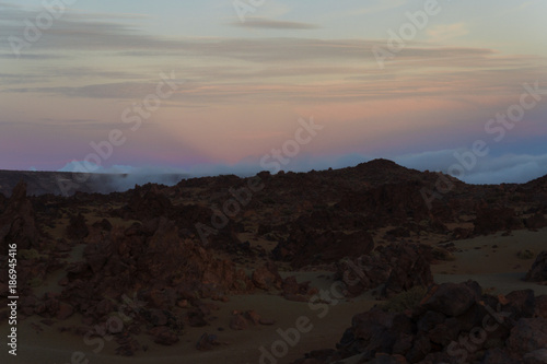 Desert landscape with sunset light on mountains in background