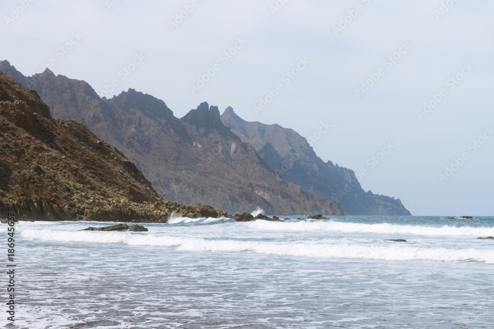 Remote sand beach in volcanic landscape in summer