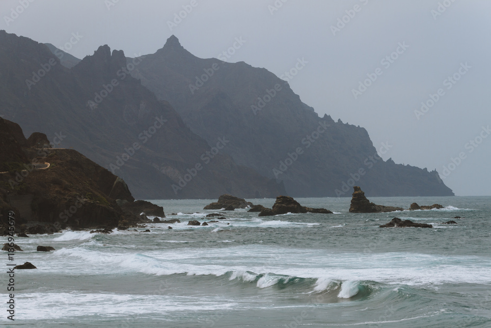 Coastline in volcanic landscape in summer in haze