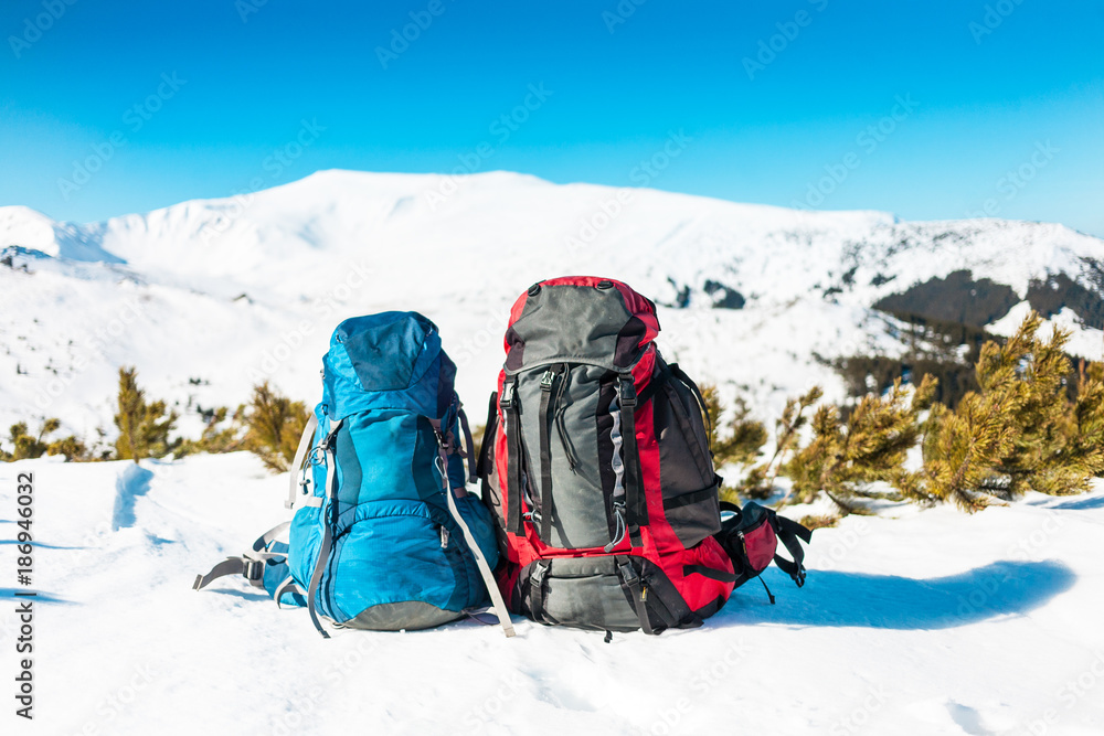 Two backpacks on the snow.