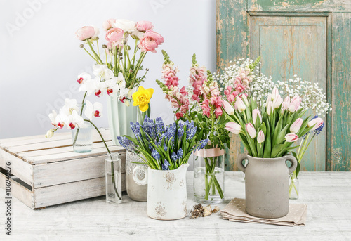 Spring flowers on wooden table. © agneskantaruk