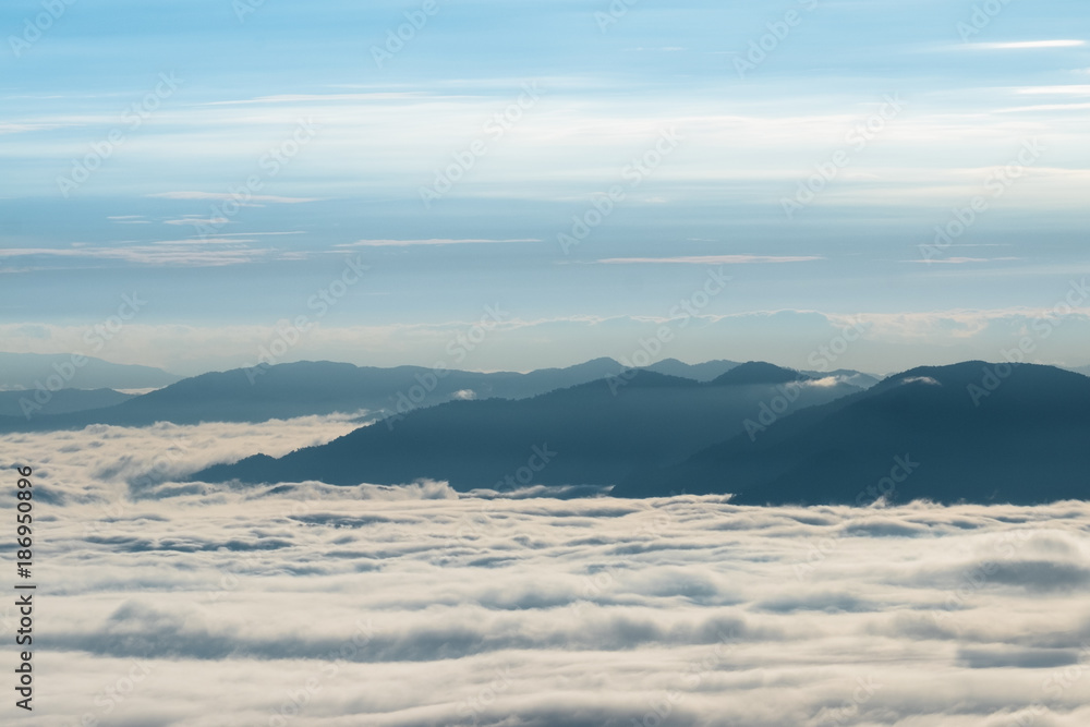 Beautiful sunrise scene at high mountain with yellow clouds and blue sky, Phu chi fah Chiangrai Thailand