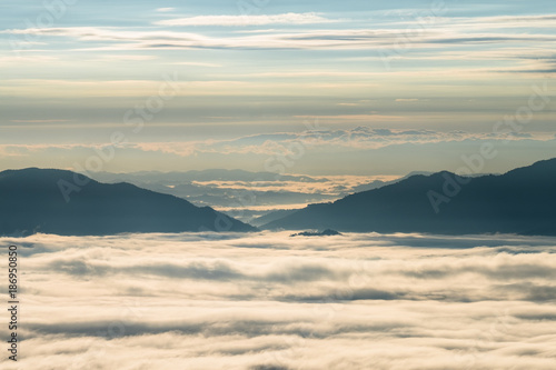 Beautiful sunrise scene at high mountain with yellow clouds and blue sky  Phu chi fah Chiangrai Thailand