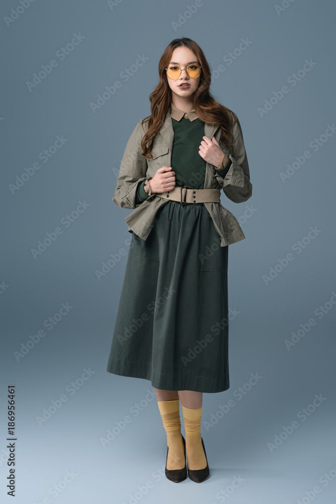 beautiful fashionable girl posing in autumn outfit, isolated on grey beautiful fashionable girl posing in autumn outfit, isolated on grey