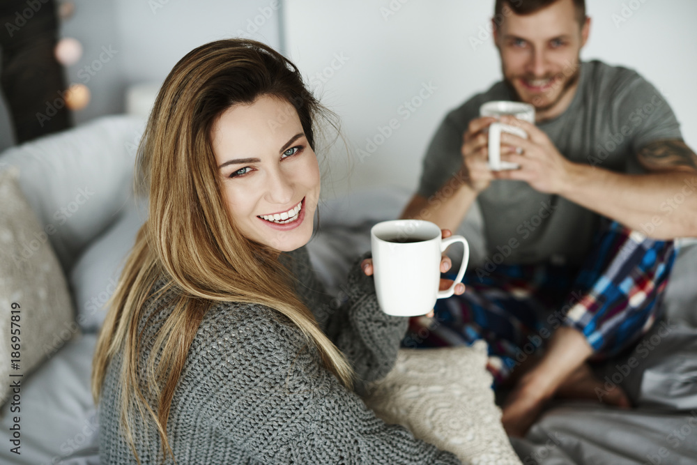 Heterosexual couple with coffee in bed Heterosexual couple with coffee in bed