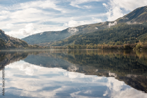 Loch Lubnaig, a part of the Loch Lomond & Trossachs National Park in Scottish Highlands. Reflection of Tree and Mountain on water, in Autumn. © moomusician