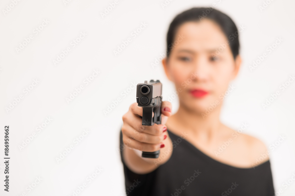 young woman asian girl holding a gun aiming at the gun, with selective focus young woman asian girl holding a gun aiming at the gun, with selective focus