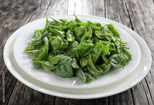 spinach leaves on a white plates, close-up