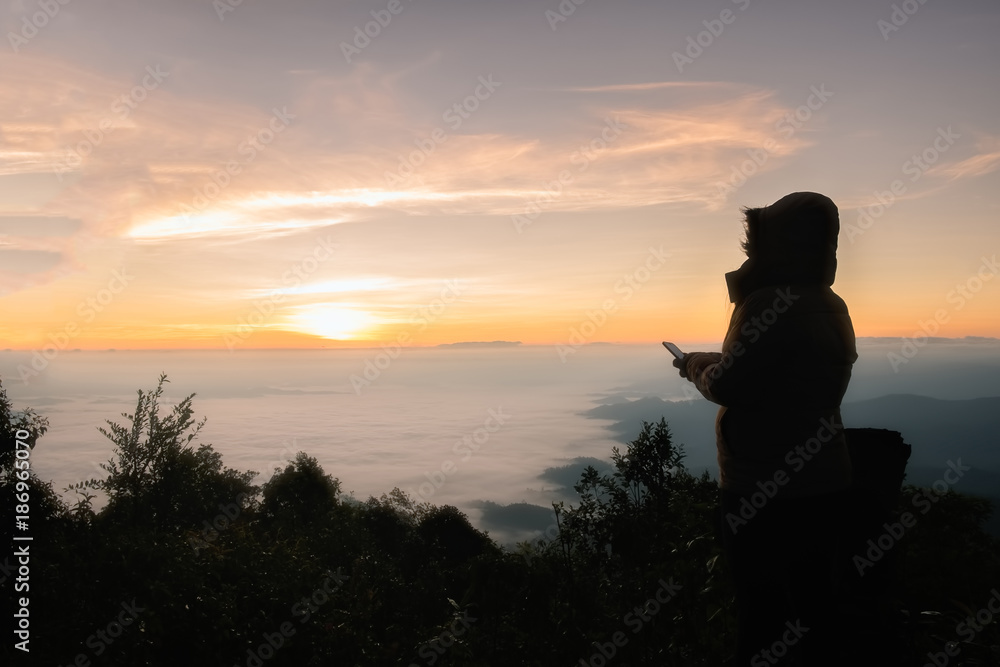 Silhouette of a person standing on top of a mountain enjoying beautiful natural landscape while out camping copyspace people lifestyle active vitality travelling hiking