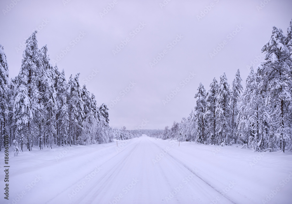 Obraz premium Empty snowy winter road in Northern Finland
