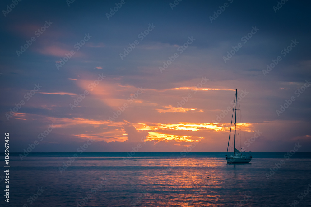 Fototapeta premium Sailboat at sunset
