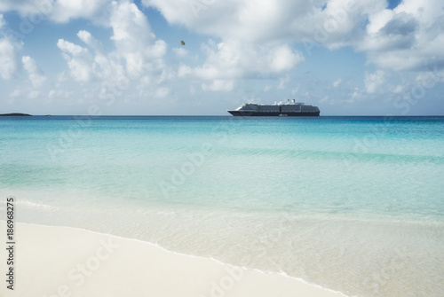 Beautiful sand beach with crystal clear water and cruise ship anchored, Bahamas © dani3315