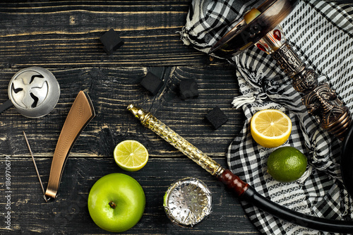 Arabic hookah with a tobacco flavor of a mixture of citruses and apple photo