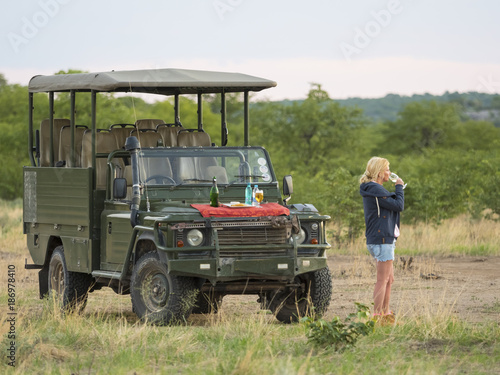 Namibia, Outjo, tourist drinking glass of champagne in Ongava Wild Reservat photo