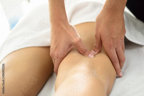 Fototapeta Naklejka Na Ścianę i Meble -  Medical massage at the leg in a physiotherapy center.