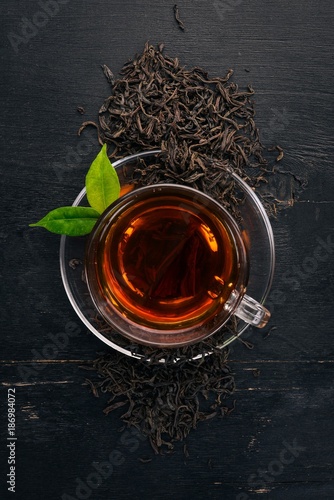Obraz na płótnie A cup of black tea on a wooden background. Top view. Copy space.
