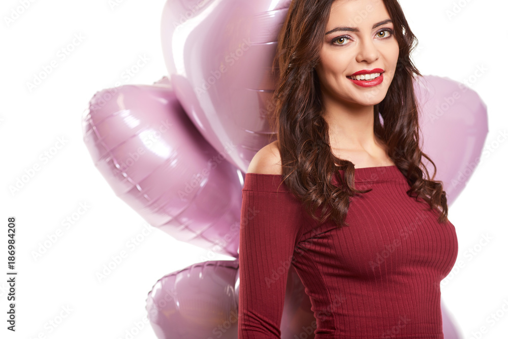 Beautiful girl, stylish fashion model with balloons in the shape of a heart. Woman on Valentine Beautiful girl, stylish fashion model with balloons in the shape of a heart. Woman on Valentine