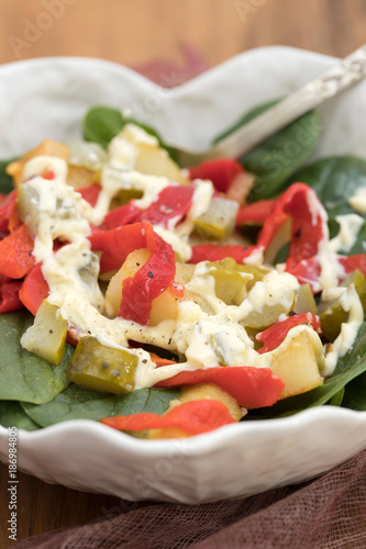 warm salad with potato , salted cucumber and red pepper