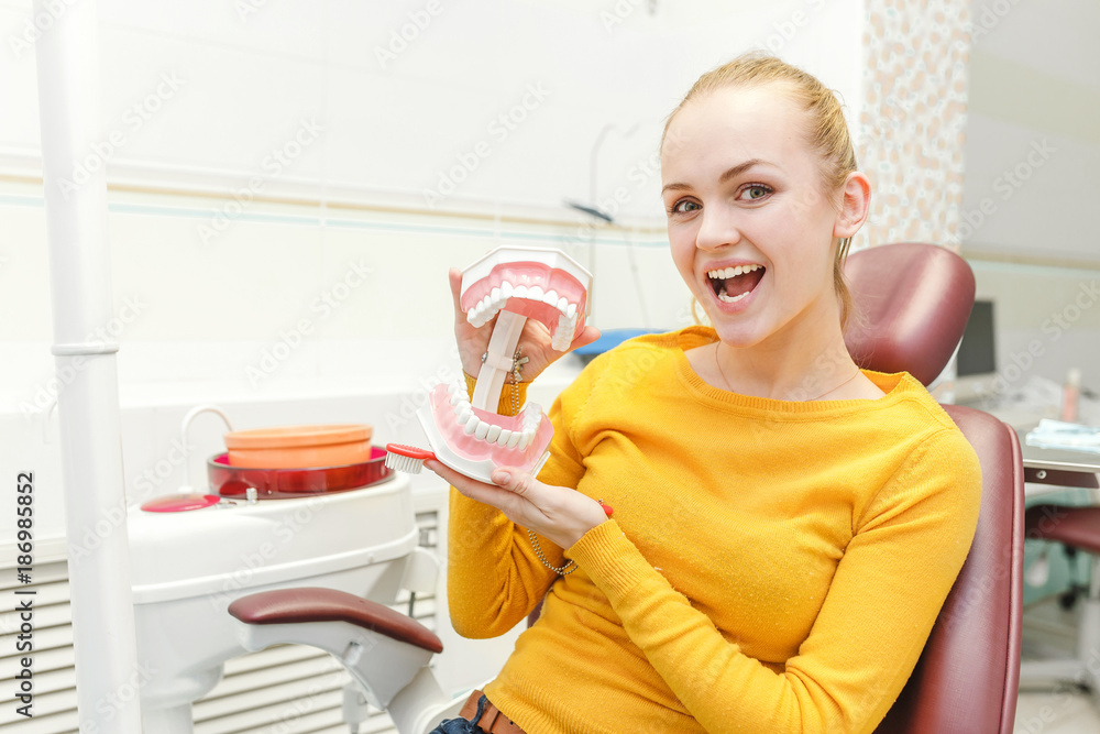 attractive woman at dental doctor holding big jaws attractive woman at dental doctor holding big jaws