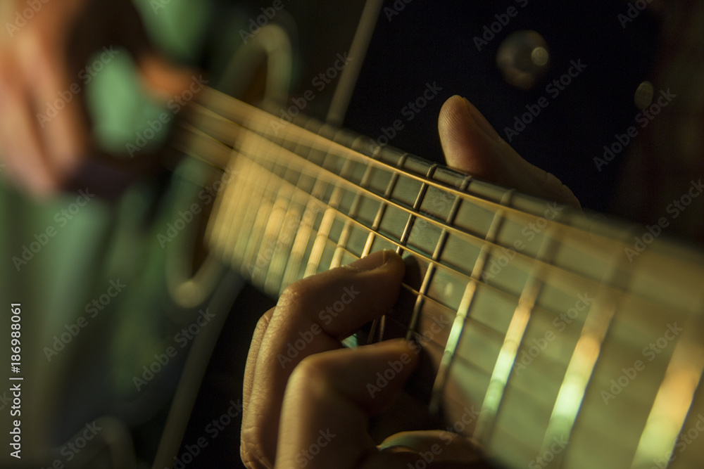 Fototapeta premium Practicing in playing guitar. Handsome young men playing guitar